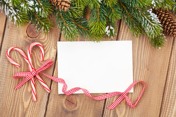 Fototapeta na wymiar Christmas tree branch and blank greeting card