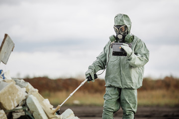 Scientist (radiation supervisor) in protective clothing and gas - obrazy, fototapety, plakaty