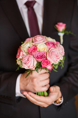 wedding bouquet in groom hand