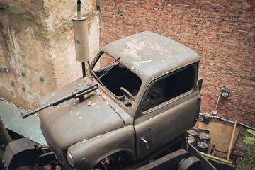 Old broken car with a machine gun in one of the courtyards Lviv