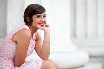 Fototapeta premium Portrait of smiling girl in urban background