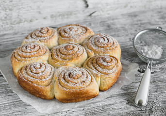cinnamon rolls on bright wooden surface