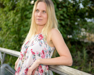 Naklejka premium Young Woman with long blond hair and blue eyes standing in the s