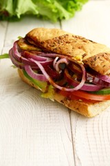 sandwiches with salad, onion, salami, pepperoni, ham, cheese and