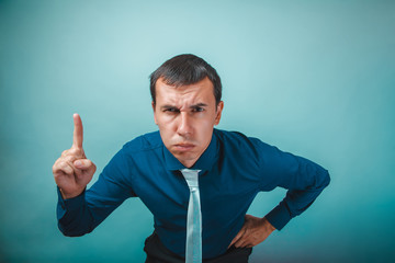 a  man of European appearance thirty years  threatens finger on 