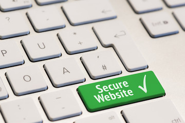 computer keyboard with the words secure website phishing on green key