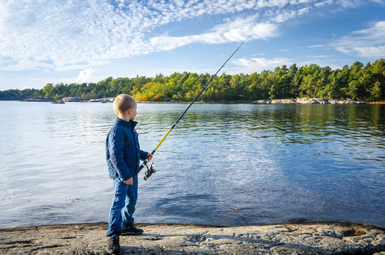 Small boy with big fishing rod