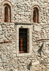 Fototapeta na wymiar Natural stone wall of an old building