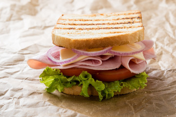 toast ham sandwich on brown paper