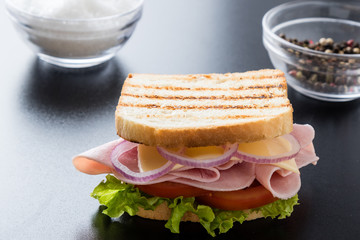 toast ham sandwich on black table