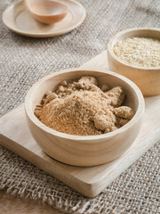 Brown sugar and wheat germ in wooden bowl
