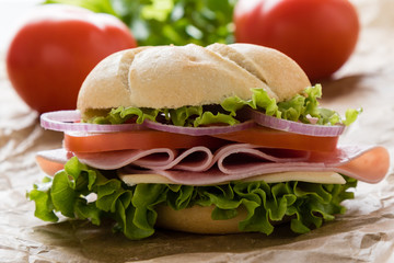 ham sandwich on brown paper