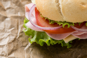 ham sandwich on brown paper