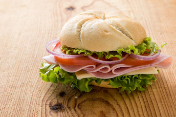 ham sandwich on wooden table