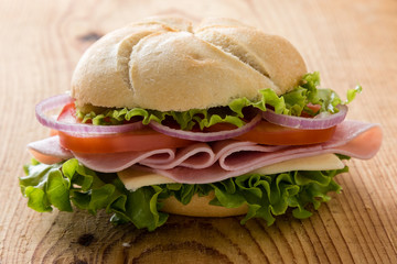 ham sandwich on wooden table