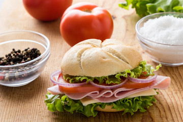 ham sandwich on wooden table