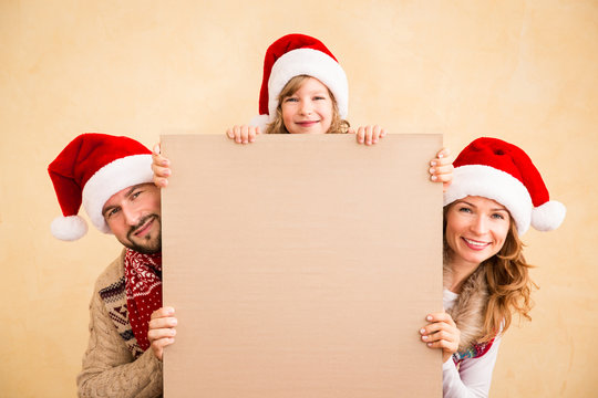 Family Holding Christmas Poster