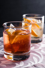 Old fashioned cocktails on the wooden background