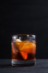 Old fashioned cocktail on the wooden background