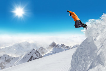 Naklejka na ściany i meble Jumping snowboarder at jump