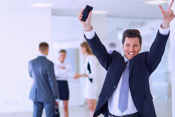 Business team celebrating a triumph with arms up 