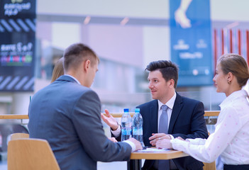 Group of happy young business people in a meeting at office