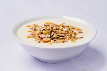 Muesli with yoghurt and fruit pieces, closeup