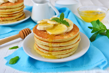 Pancake with banana, covered with honey or maple syrup