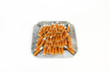 Pile of the cigarette butts in the ashtray