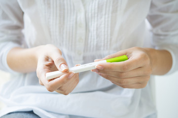 Woman holding pregnancy test