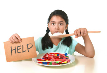 little child eating sweet sugar in candy dish holding sugar spoo