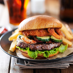 western barbecue hamburger with onion rings and french fries