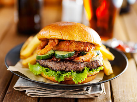 western barbecue burger with onion rings and sauce served with french fries