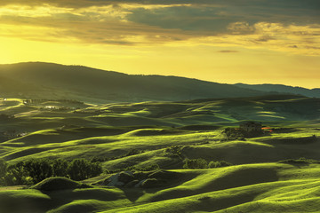 Tuscany spring, rolling hills on sunset. Rural landscape. Green