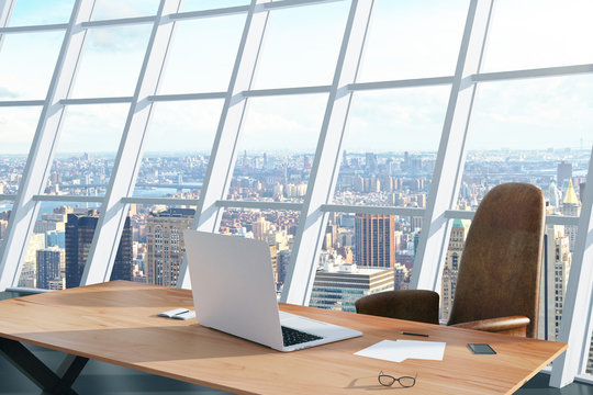 Modern workplace with laptop and city view