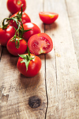 Fresh cherry tomatoes on rustic wooden background