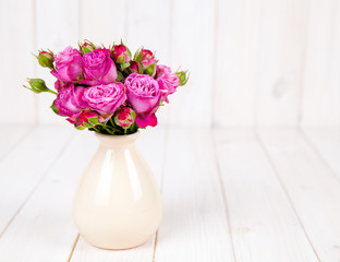 fresh flowers roses on white wooden background