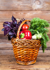 fresh vegetables in the basket on wooden background
