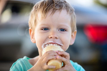 Cute little boy eating ice-cream and smiling