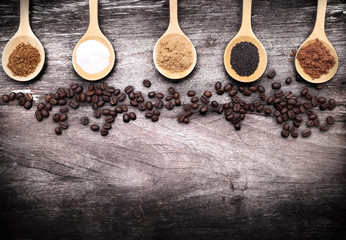 grated coffee in spoon on roasted coffee beans background