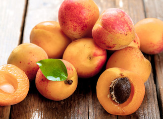 Naklejka na ściany i meble Apricot. Organic fruits with leaf on wooden background