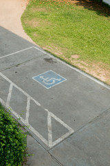 parking space reserved handicapped on road with disabled sign
