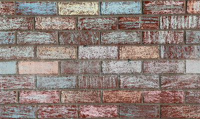 A brick wall at a school covered with colored chalk..