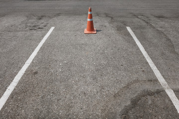 parking lot with traffic cone on street used warning sign