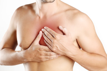 Fototapeta premium Chest Pain, Young man holding hand to spot chest pain