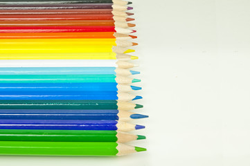 Colorful pencils on white desk - creative background