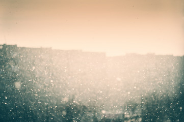 Snowfall in the sity. Blurred winter background