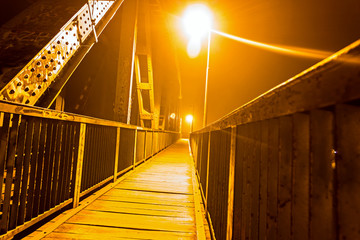 Bridge illuminated with lights at night.