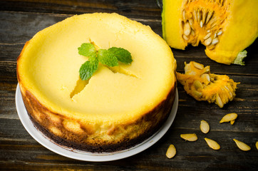 Homemade pumpkin cheesecake on wooden background,Thanksgiving day