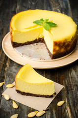 Homemade pumpkin cheesecake on wooden background,Thanksgiving day